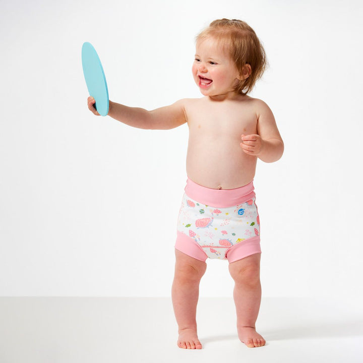Lifestyle image of little one wearing swim nappy, front.