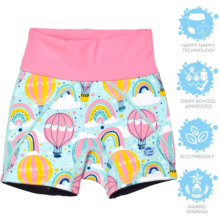 Lifestyle image of child wearing neoprene swim shorts in baby blue with pink waist and hot air balloons themed print, including clouds and rainbows.
