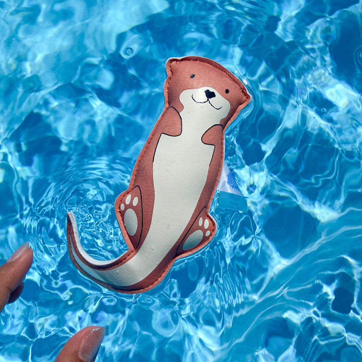 Otter themed neoprene toy, floating in the pool