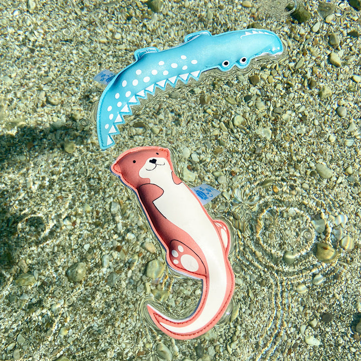 Otter and crocodile themed neoprene toys, floating in the river