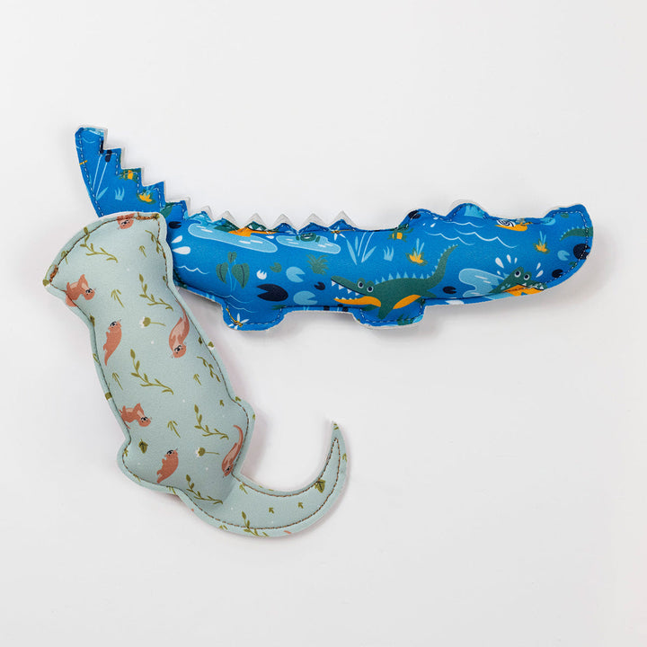 Flat lay image of crocodile and otter themed neoprene toys, back