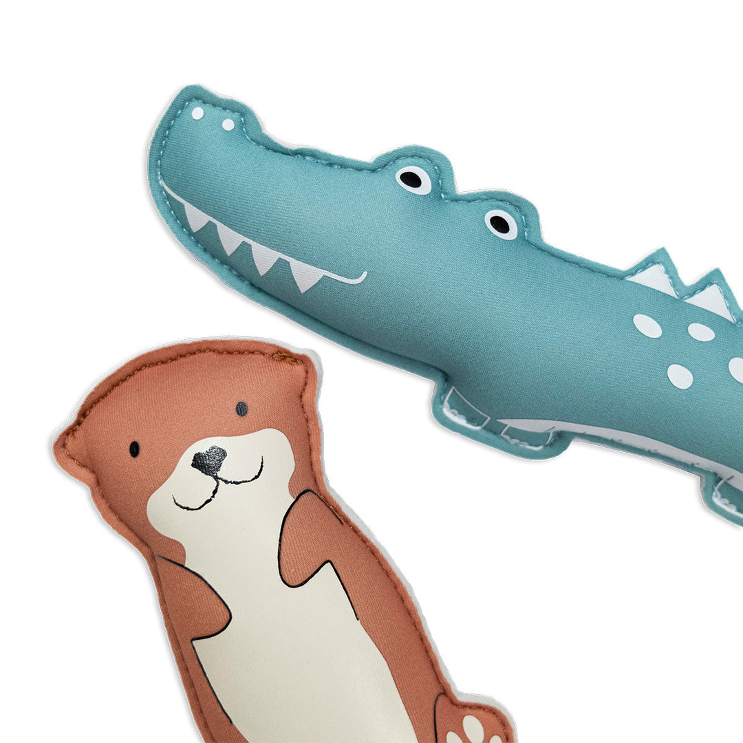 Flat lay image of crocodile and otter themed neoprene toys, back