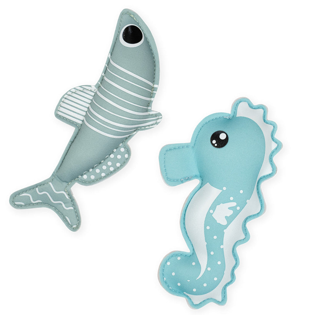 Flat lay image of sardine and seahorse themed neoprene toys, light blue side