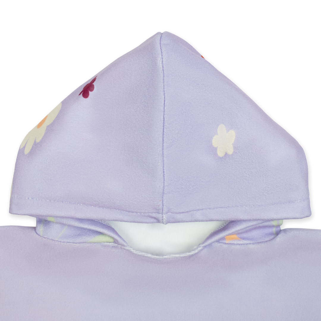 Flat lay image of poncho towel in lilac with floral themed print. Close up of the hood.