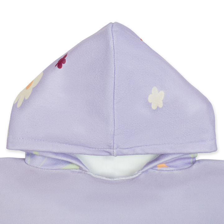 Flat lay image of poncho towel in lilac with floral themed print. Close up of the hood.