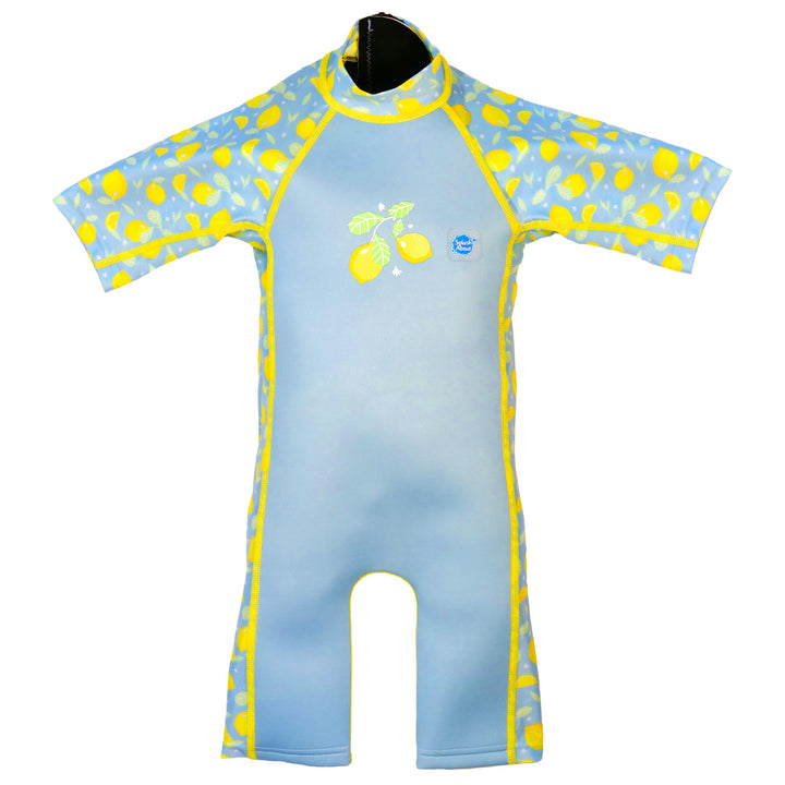 One piece UV sun and sea wetsuit for toddlers in light blue, featuring lemons themed print on sleeves, side panels, neck and chest. Front.
