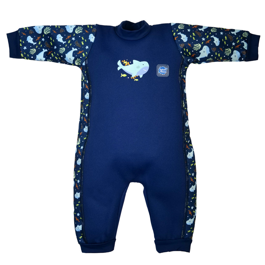 Flat lay image of fleece-lined baby wetsuit in navy with sharks themed print. Front.