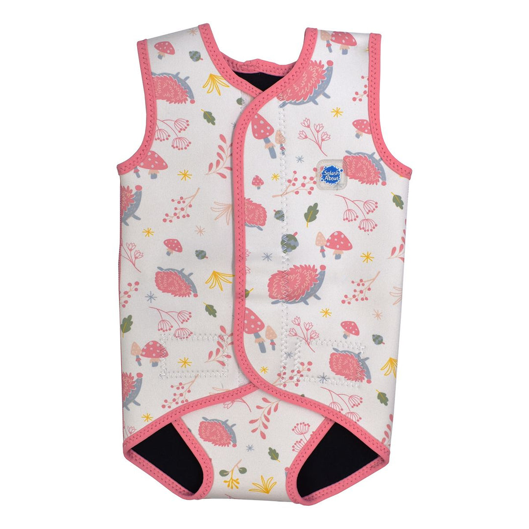 Neoprene baby wrap wetsuit in white with pink trims and forest themed print, including hedgehogs, mushrooms, flowers and leaves. Front.