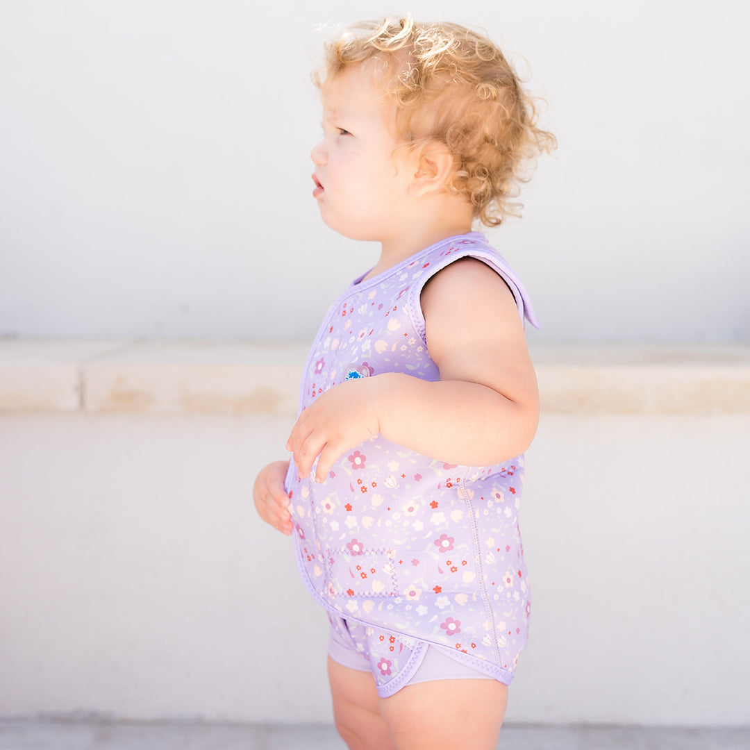 Neoprene baby wrap wetsuit in lilac with floral print.