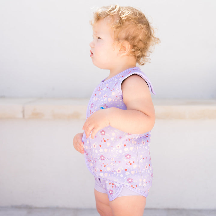 Neoprene baby wrap wetsuit in lilac with floral print.
