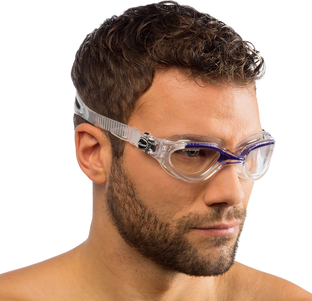 Man wearing clear and blue swim goggles