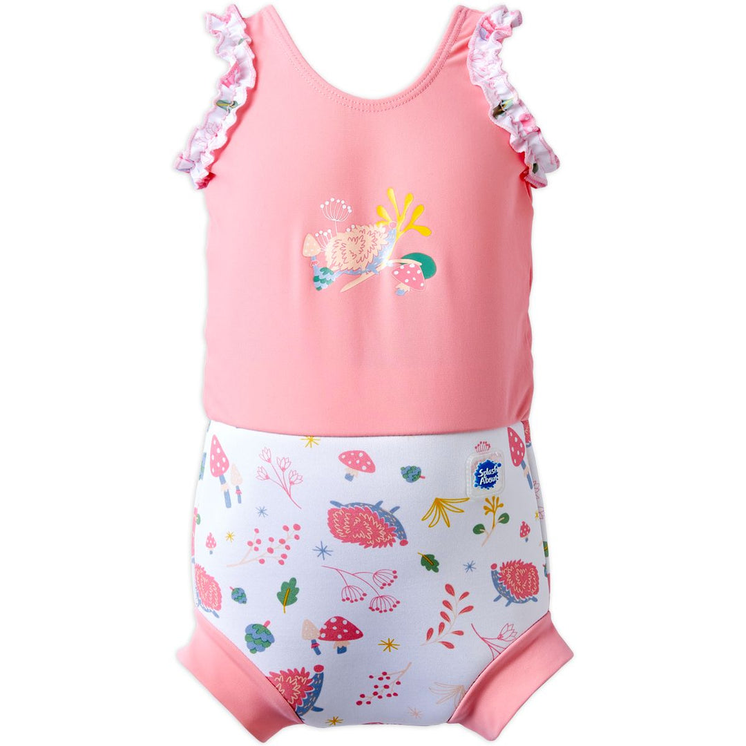 Happy Nappy Costume in pink and white featuring forest themed print, including hedgehogs, mushrooms and leaves. Front.