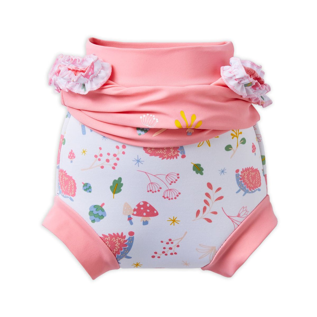 Happy Nappy Costume in pink and white featuring forest themed print, including hedgehogs, mushrooms and leaves. The top has been scrunched down to reveal the built-in Happy Nappy underneath.