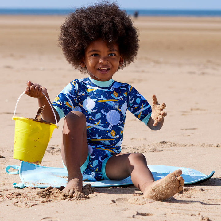 Child on neoprene mat at the beach