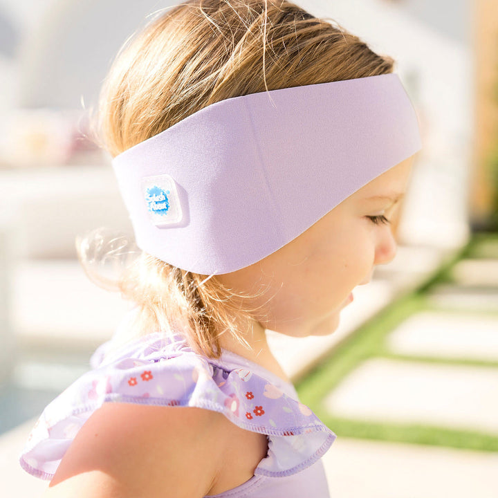 Little one wearing swim ear band in lilac, side