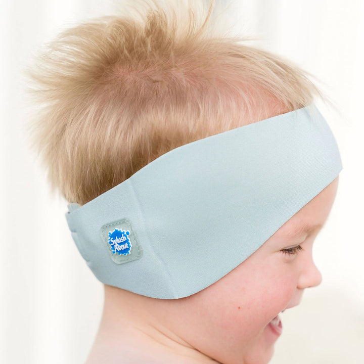 Little one wearing swim ear band in pistachio, side