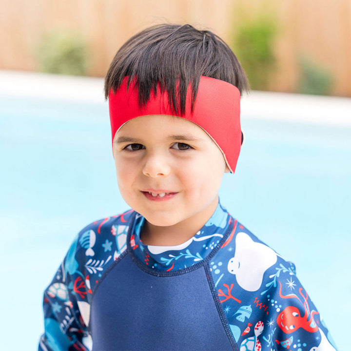 Little one wearing swim ear band in red, front