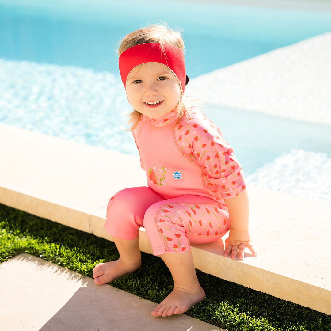 Little one wearing swim ear band in red, front