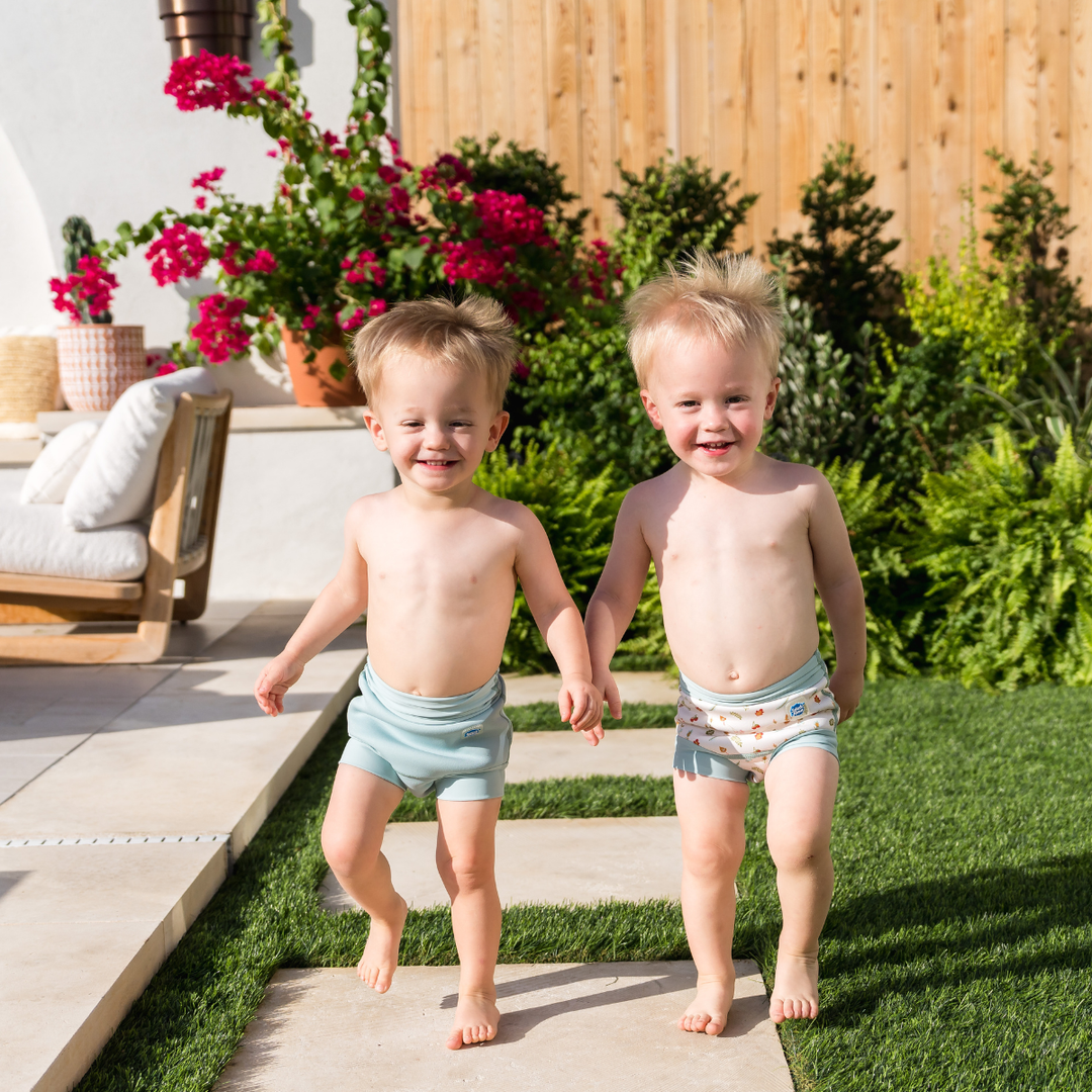 Children wearing reusable swim nappy in pistachio. Front