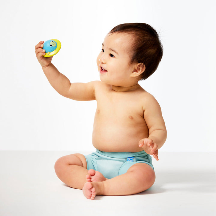 Little one wearing neoprene swim nappy, in pistachio colour.