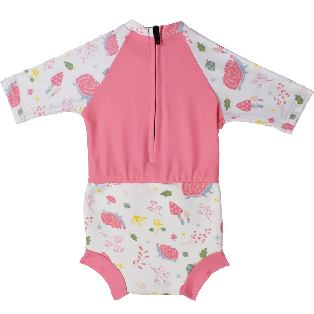 Happy Nappy Sunsuit in pink and forest themed print, including hedgehogs, mushrooms and leaves. Pink back panel with zip. Back.
