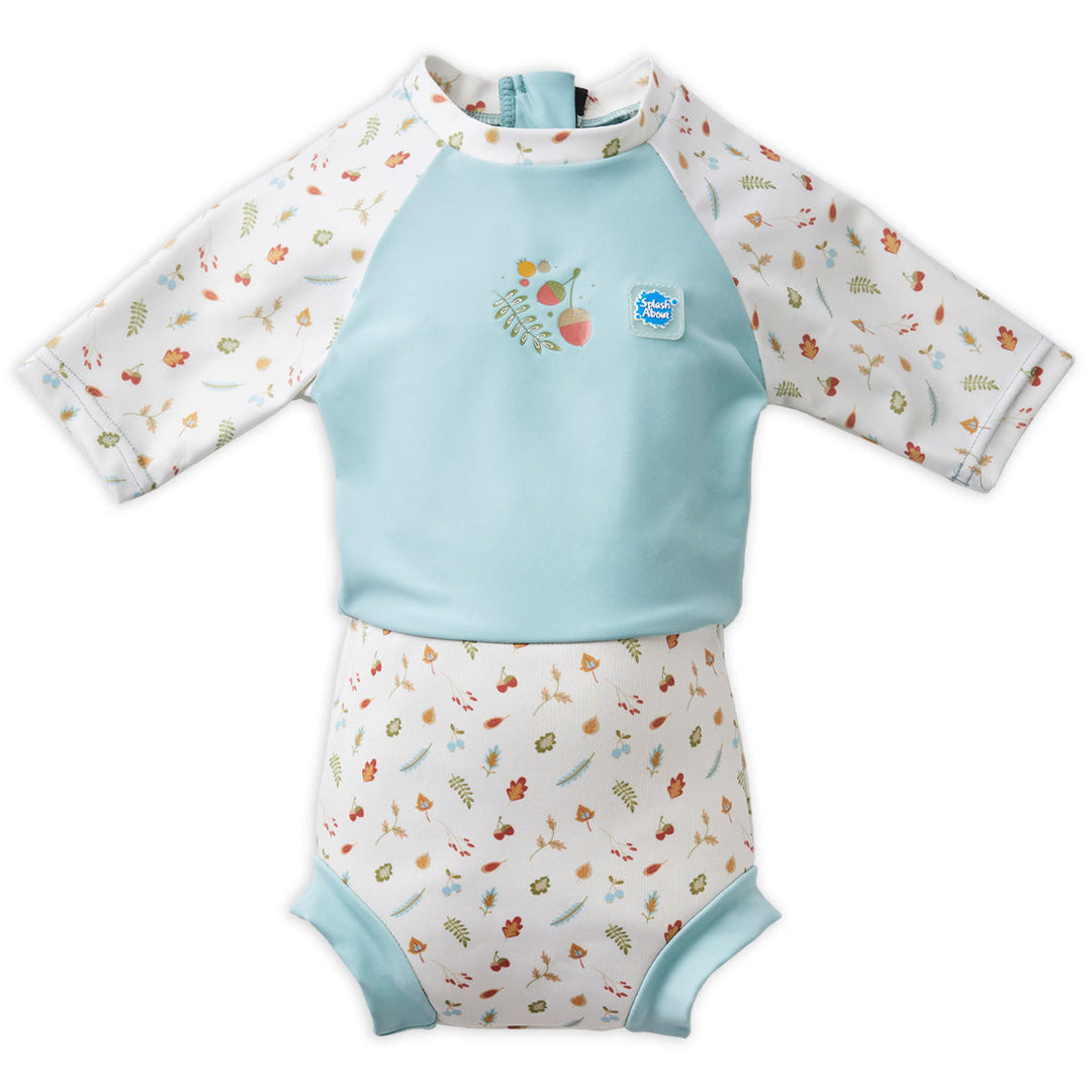 Happy Nappy Sunsuit in light blue and white, and acorns and leaves themed print. Front.