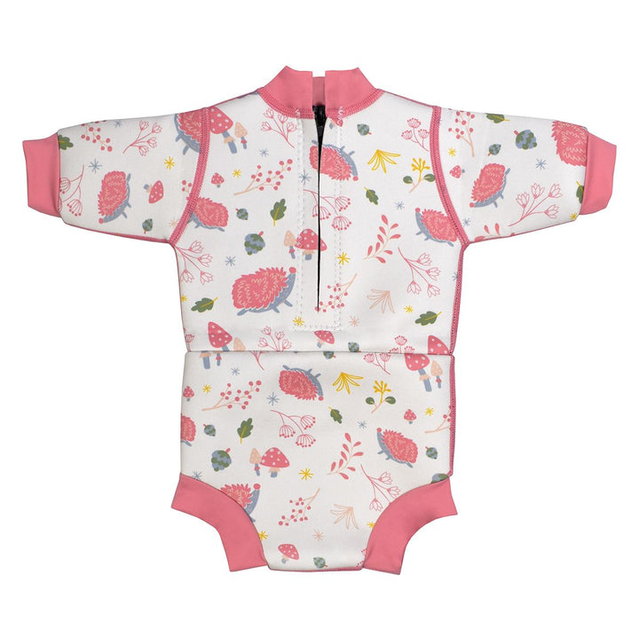 Baby wetsuit with built in swim nappy in white with pink trims and forest themed print, including hedgehogs, mushrooms and leaves. Back.