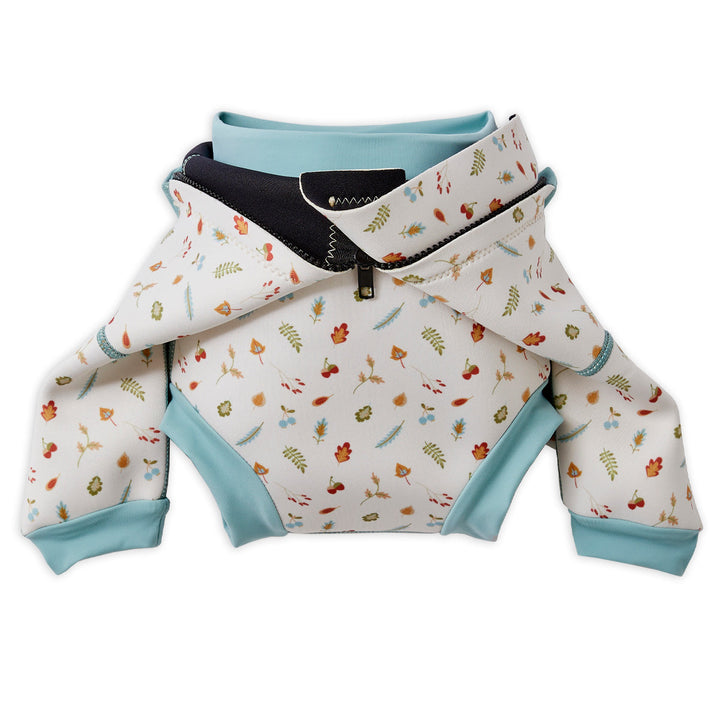 Baby wetsuit with built in swim nappy in white with light blue trims and leaves and acorns themed print. Built-in nappy.