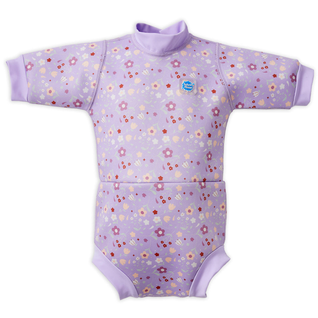 Baby wetsuit with built in swim nappy in lilac with floral themed print. Front.