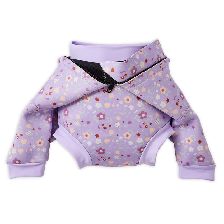 Baby wetsuit with built in swim nappy in lilac with floral themed print. Buit-in nappy.