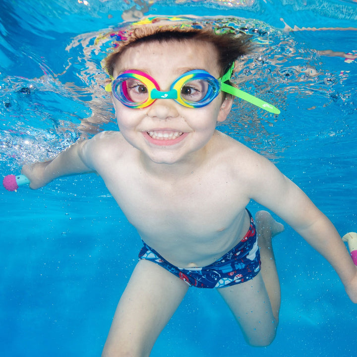 Little one wearing colourful goggles in the pool