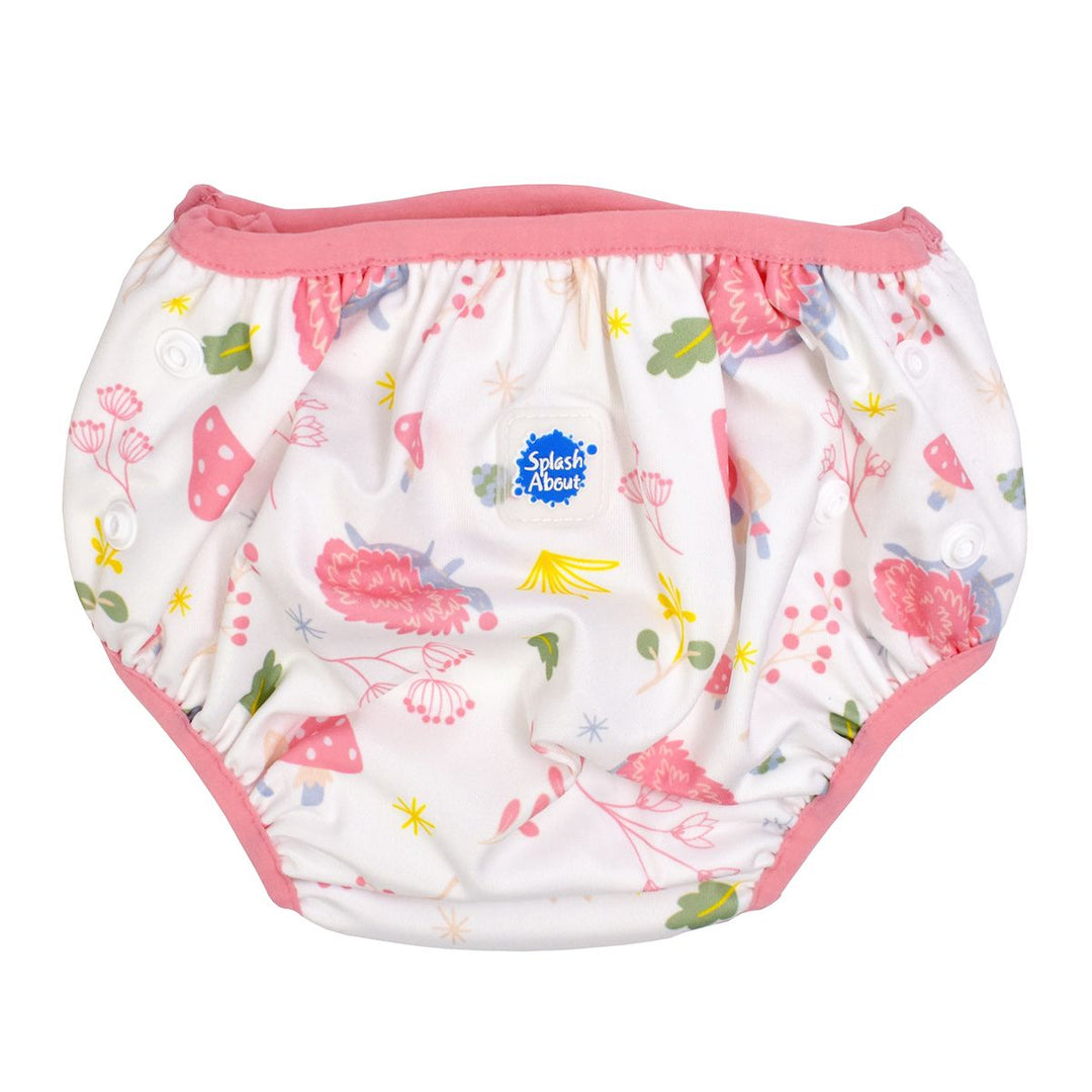 Under nappy in white with pink trims and forest themed print, including mushrooms, hedgehogs, leaves and flowers. Size adjustable with poppers. Front.