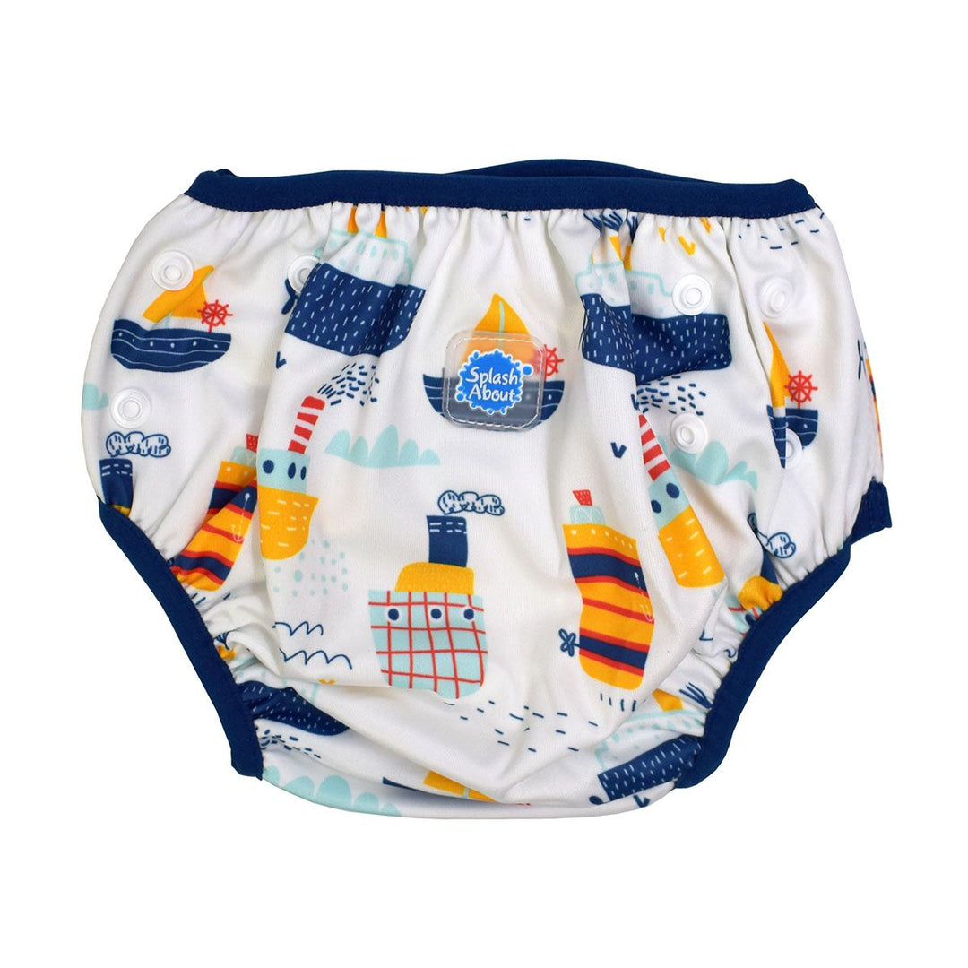 Under nappy in white with navy trims and boats themed print. Size adjustable with poppers. Front.