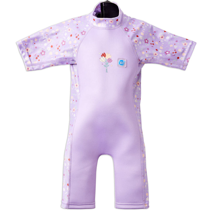 One piece UV sun and sea wetsuit for toddlers in lilac featuring floral print on sleeves, side panels, neck and chest. Front.