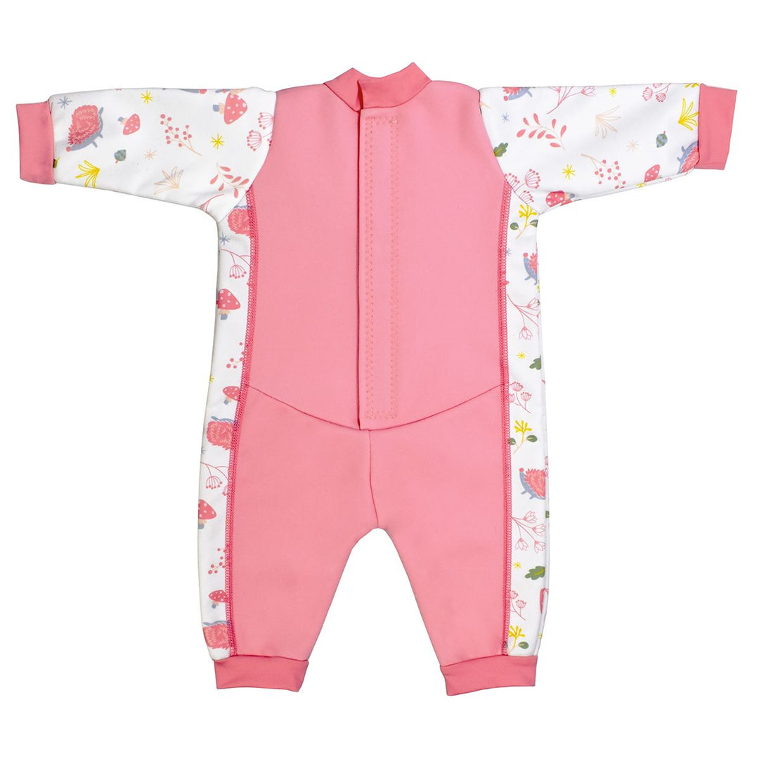 Fleece-lined baby wetsuit in pink and white with pink trims and forest themed print, including hedgehogs, mushrooms, flowers and leaves. Back.