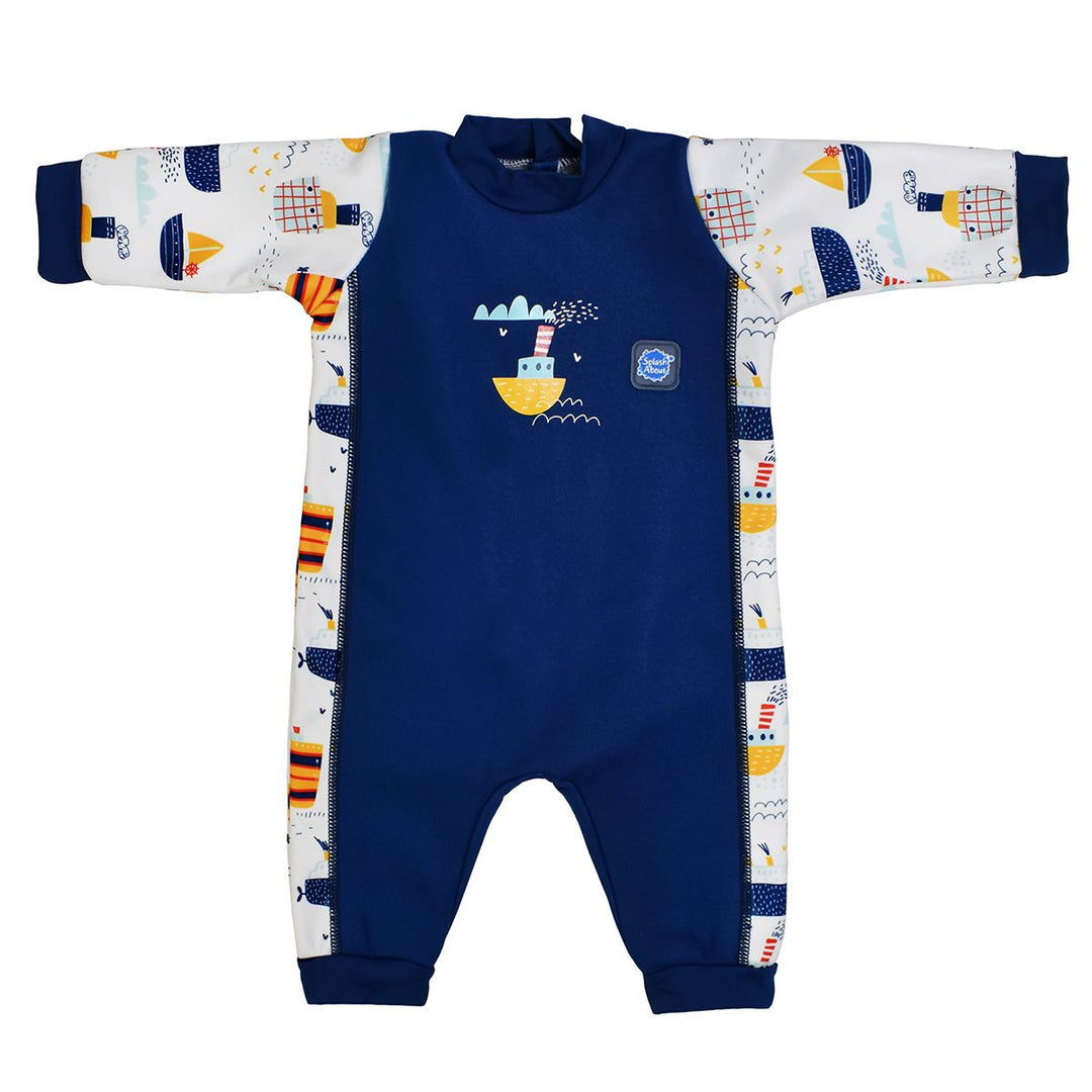 Fleece-lined baby wetsuit in navy and white with boats themed print on arms, side panels and chest. Front.