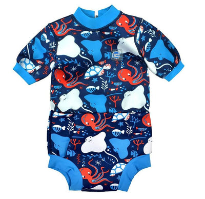 Baby wetsuit with built in swim nappy in navy blue and under the sea themed print, including octopus, turtles, fish, sea ray and more. Blue trims. Front.