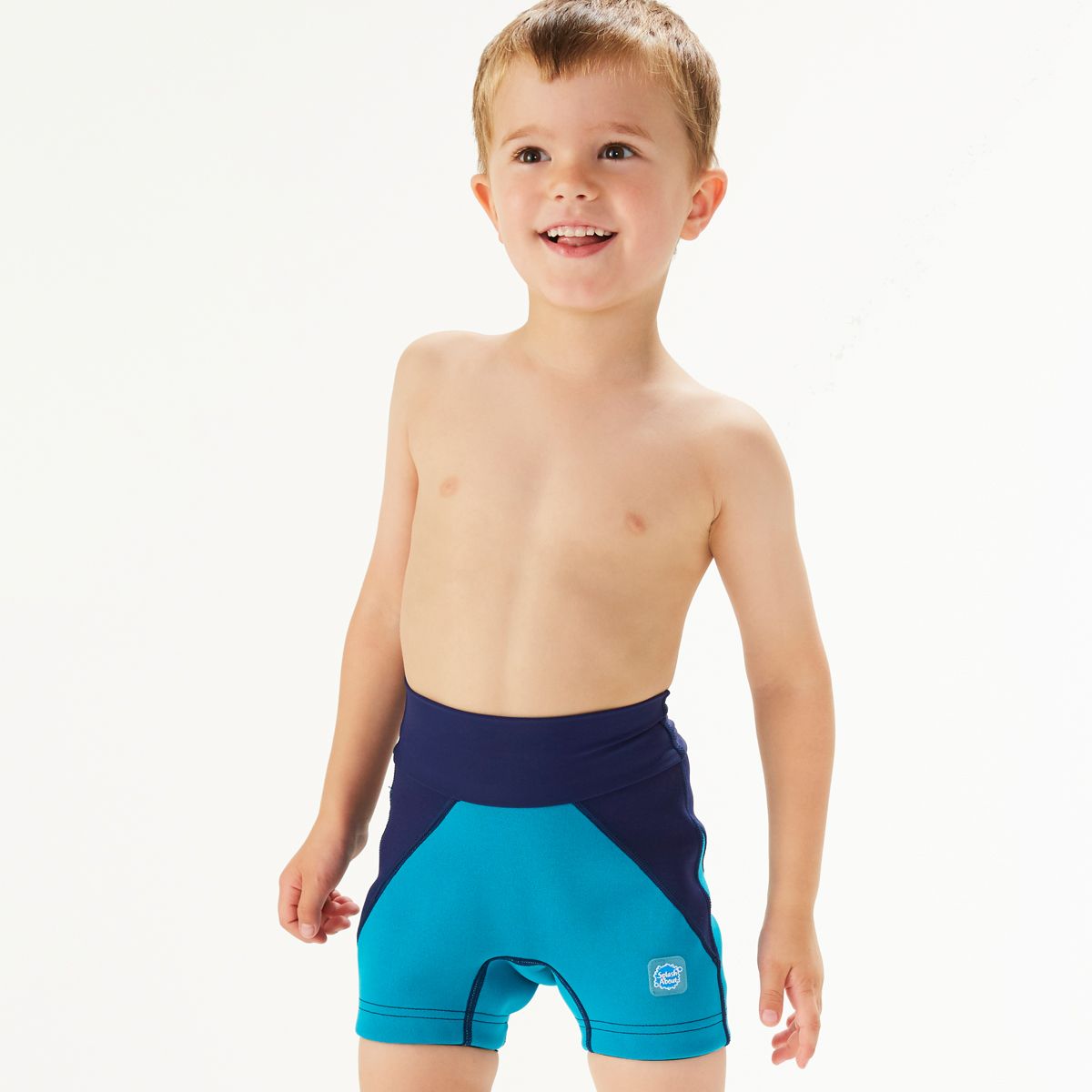 Lifestyle image of child wearing neoprene swim shorts in navy blue and jade.
