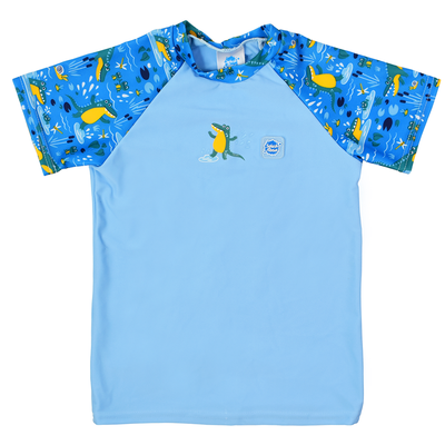 UV protective short sleeve rash top in light blue, and crocodile swamp themed print on the chest and sleeves, including crocodiles, frogs, fireflies and more. Front.