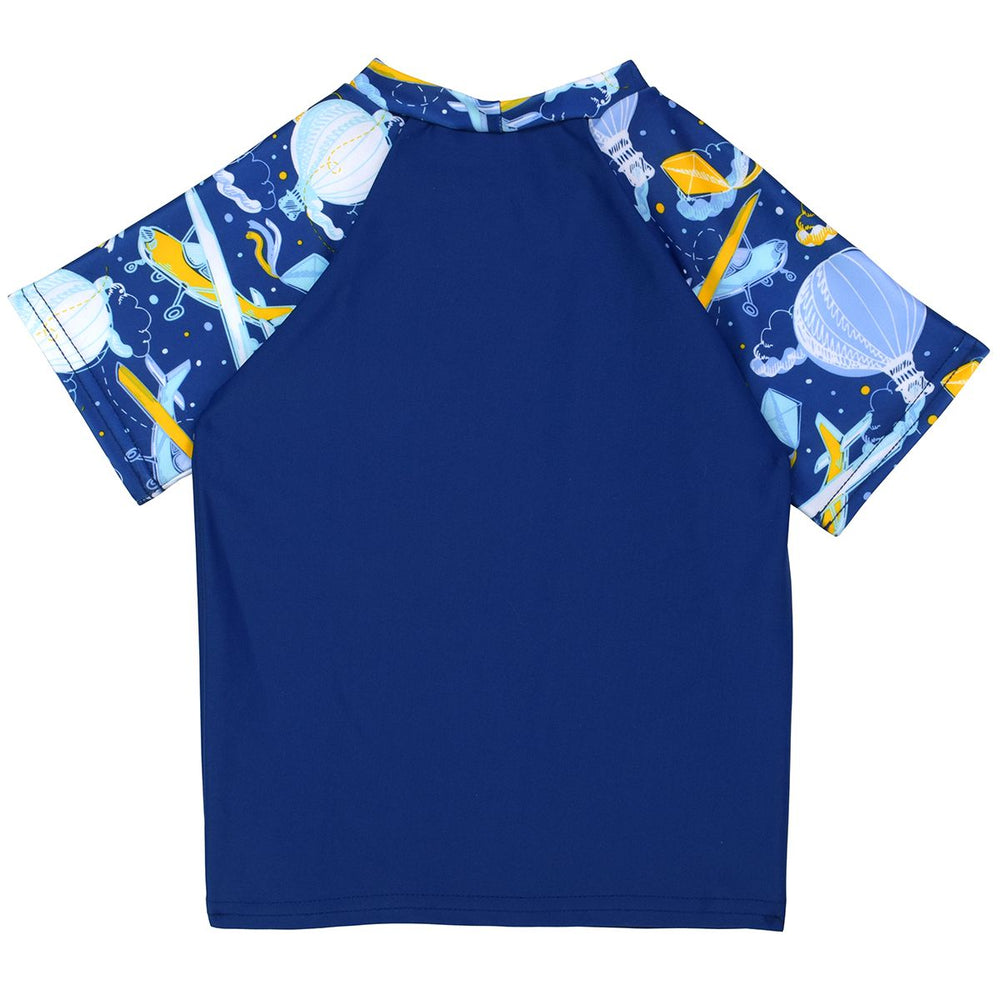 UV protective short sleeve rash top in navy blue, and sky themed print on sleeves, including airplanes, kites, hot air balloons and clouds. Back.